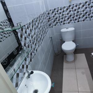 a bathroom with a toilet and a sink at Dca villa homestay in Kota Bharu