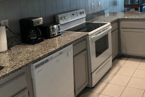 a kitchen with a stove and a toaster oven at Grandview in Ocean City
