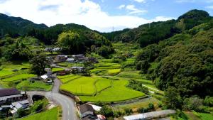 an aerial view of a small village in the mountains at Kitsunenotebukuro in Misato