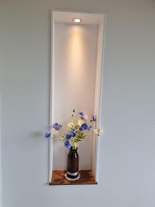 a vase with blue and white flowers sitting on a shelf at Stay Gyeongju in Gyeongju