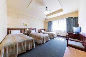Säng eller sängar i ett rum på Hakuba Hotel Paipu no Kemuri