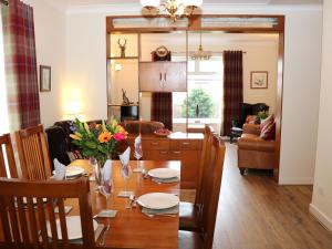 a dining room and living room with a table and chairs at Cherry Fields in Chesterfield