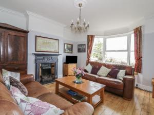 a living room with a couch and a fireplace at Lighthouse View in Great Yarmouth