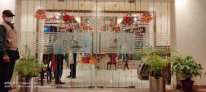 a store window with christmas decorations in a store at Hotel Landmark in Gwalior