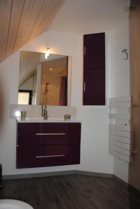 a bathroom with a sink and a mirror at Gîte Auberoques Aveyron- maison indépendante- classée 3 étoiles in Les Fonds