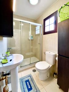a bathroom with a shower and a toilet and a sink at Sun Beach 89 in Caleta De Fuste