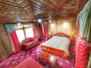 a bedroom with a bed and a chair in a room at Raja's Palace Houseboat - Kashmir in Srinagar