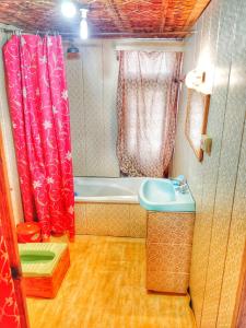 a bathroom with a tub and a shower curtain at Raja's Palace Houseboat - Lake View in Srinagar +31 photos