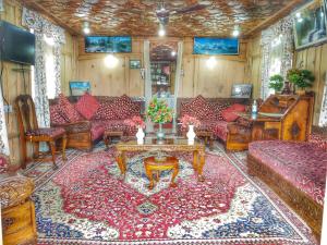 a living room with couches and a table at Houseboat Raja's Palace in Srinagar
