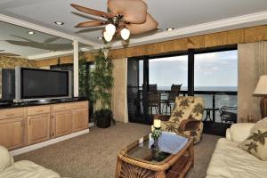 a living room with a flat screen tv and a couch at Golden Sands XII in Ocean City