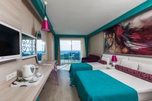 a hotel room with two beds and a tv at Sultan of Dreams Hotel & Spa in Kızılot