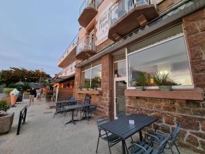 a group of tables and chairs outside of a building at Hotel De L'Europe in Perros-Guirec