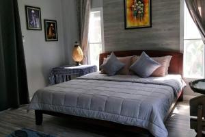 ein Schlafzimmer mit einem Bett und einer Lampe auf einem Tisch in der Unterkunft Seabreeze Cottage in Ko Chang