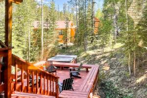 a wooden deck with a picnic table and chairs on it at The GingerBreck House in Breckenridge
