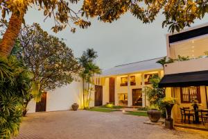 an exterior view of a building with a courtyard at Nyne Hotels - Lake Lodge, Colombo in Colombo