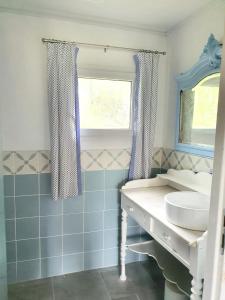 a blue bathroom with a sink and a window at Maison charmante à Montfermier avec piscine privée in Montfermier +12 photos