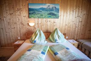 ein Schlafzimmer mit einem Bett mit einem Bild an der Wand in der Unterkunft Buchmann Lehen in Irdning