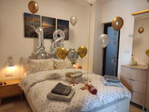 a bedroom with balloons and a bed with a bed at ARAD-DEAD SEA BASHIRIS PLACE in Arad +18 photos