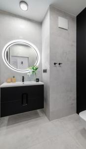 a bathroom with a sink and a mirror at Apartament Baltica Portova Gdynia in Gdynia +26 photos