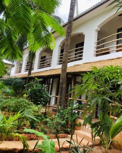 an exterior view of a building with trees and plants at Siri Beach Lodge in Nungwi