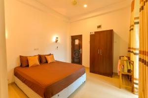 a bedroom with a bed and a cabinet in it at 2B1 weligama in Weligama