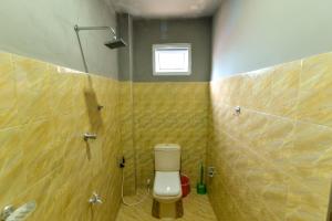 a small bathroom with a toilet and a shower at 2B1 weligama in Weligama +30 photos