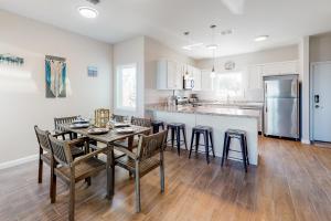 a kitchen and dining room with a table and chairs at Las Joyas Bayview Home #202 in Port Isabel