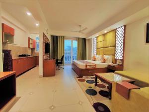 a hotel room with a bed and a living room at The Angel Hotel & Suites near Medanta in Gurgaon
