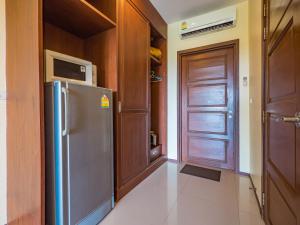 a kitchen with a stainless steel refrigerator and a door at Condo AVANTA Unit А405 in Ban Tai