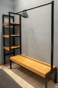 a room with a wooden shelf and a bookcase at City Twins in Thessaloniki