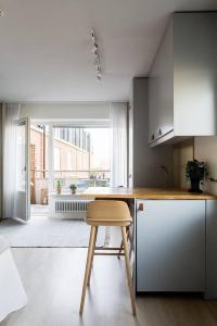 a kitchen with a table and a stool in a room at Avanti Apartment Hotel in Stockholm