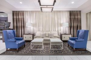 a living room with a couch and two blue chairs at Wyndham Philadelphia-Historic District in Philadelphia