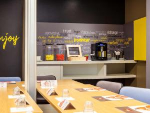 a meeting room with two tables and a chalkboard wall at ibis Paris Gare De L'Est TGV in Paris