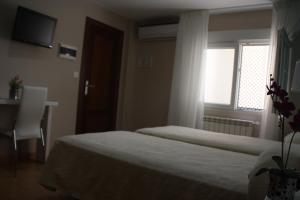 Posteľ alebo postele v izbe v ubytovaní Verona