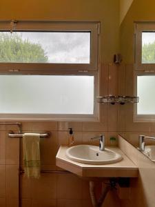 a bathroom with a sink and a window at Carpe Diem Azores in Mosteiros