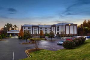 a building with a parking lot in front of it at Comfort Inn Greenville - Haywood Mall in Greenville