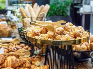 a display of pastries and breads in a bakery at Mercure Katowice Centrum in Katowice