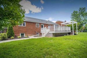 a brick house with a porch and a large yard at Arlington, VA for Lovers and Friends in Arlington