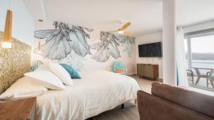 a bedroom with a bed with white sheets and a window at Etti-Paradise Suite La Ballena in Pájara
