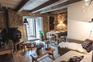 a living room with a couch and a table at Petite maison d'Amelotte in Sainte-Cécile