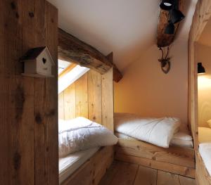 a bedroom with two beds and a window at Petite maison d'Amelotte in Sainte-Cécile