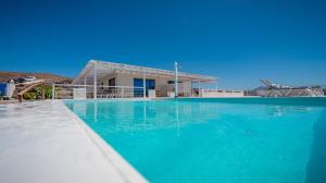 a large swimming pool in front of a house at Etti-Paradise Suite La Ballena in Pájara