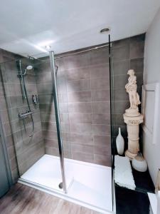 a shower with a glass door in a bathroom at Victoriana Apartment - Private Balcony in Stratford-upon-Avon