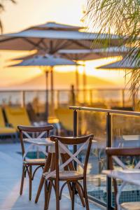 two chairs and a table with an umbrella at Sundia Exclusive By Liberty Fethiye Adults Only in Fethiye