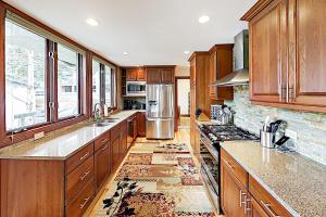 a kitchen with wooden cabinets and a stainless steel refrigerator at Tamarak 6 in Snowmass