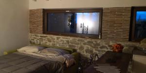 a living room with a tv on a brick wall at Ca' delle Sore in Arezzo +22 photos