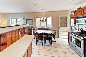 a kitchen with a table and a dining room at Harbor Point Cottage in Bourne