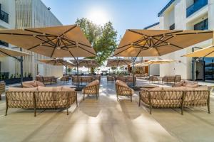 a patio with tables and chairs and umbrellas at Sundia Exclusive By Liberty Fethiye Adults Only in Fethiye
