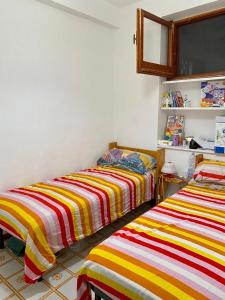 two beds sitting next to each other in a room at Casa Mare Costa Saracena - Castelluccio in Agnone Bagni