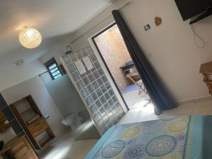 a bedroom with a bed and a door to a bathroom at Le MélanZé in Grande Anse